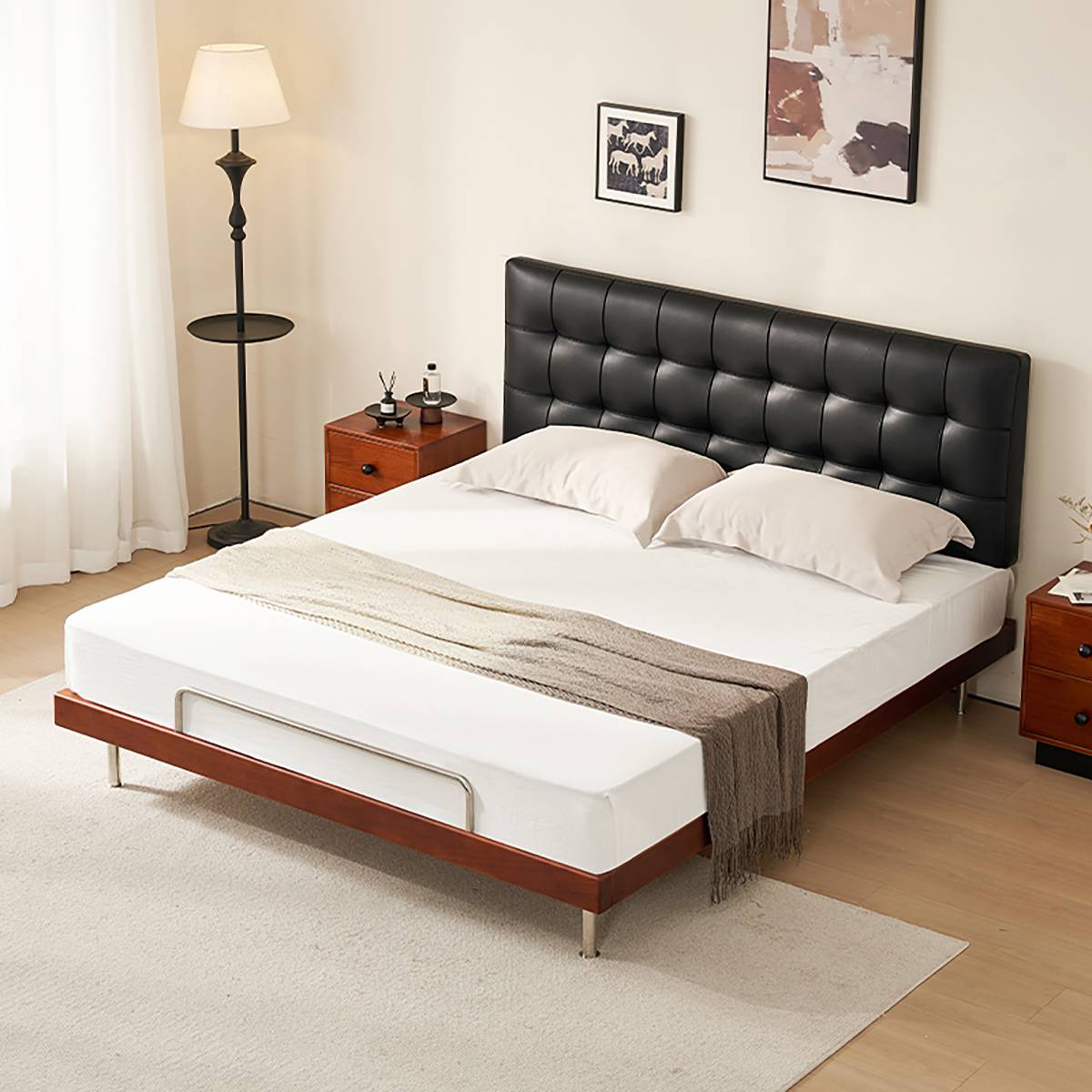 Side view of the black waffle tufted bed with white bedding