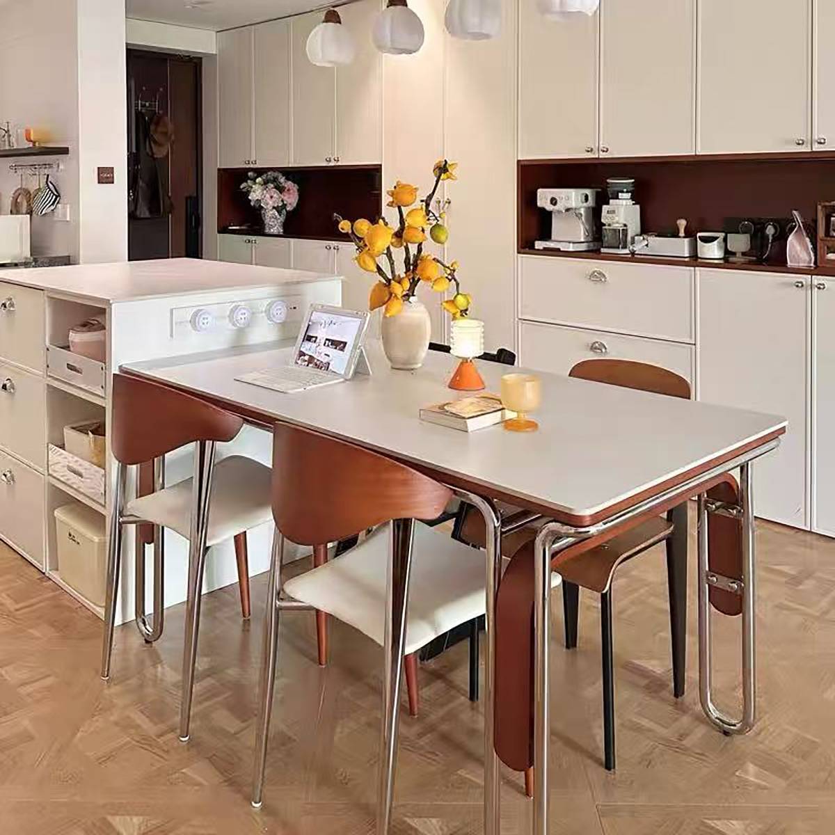 White sintered stone dining table with stainless steel frame in a dining room setting