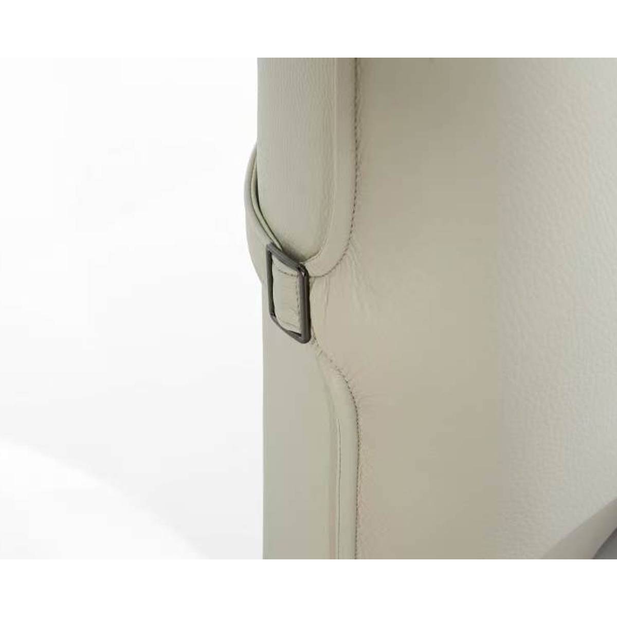 Close-up detail of the bed frame side showing the leather texture and metal buckle strap