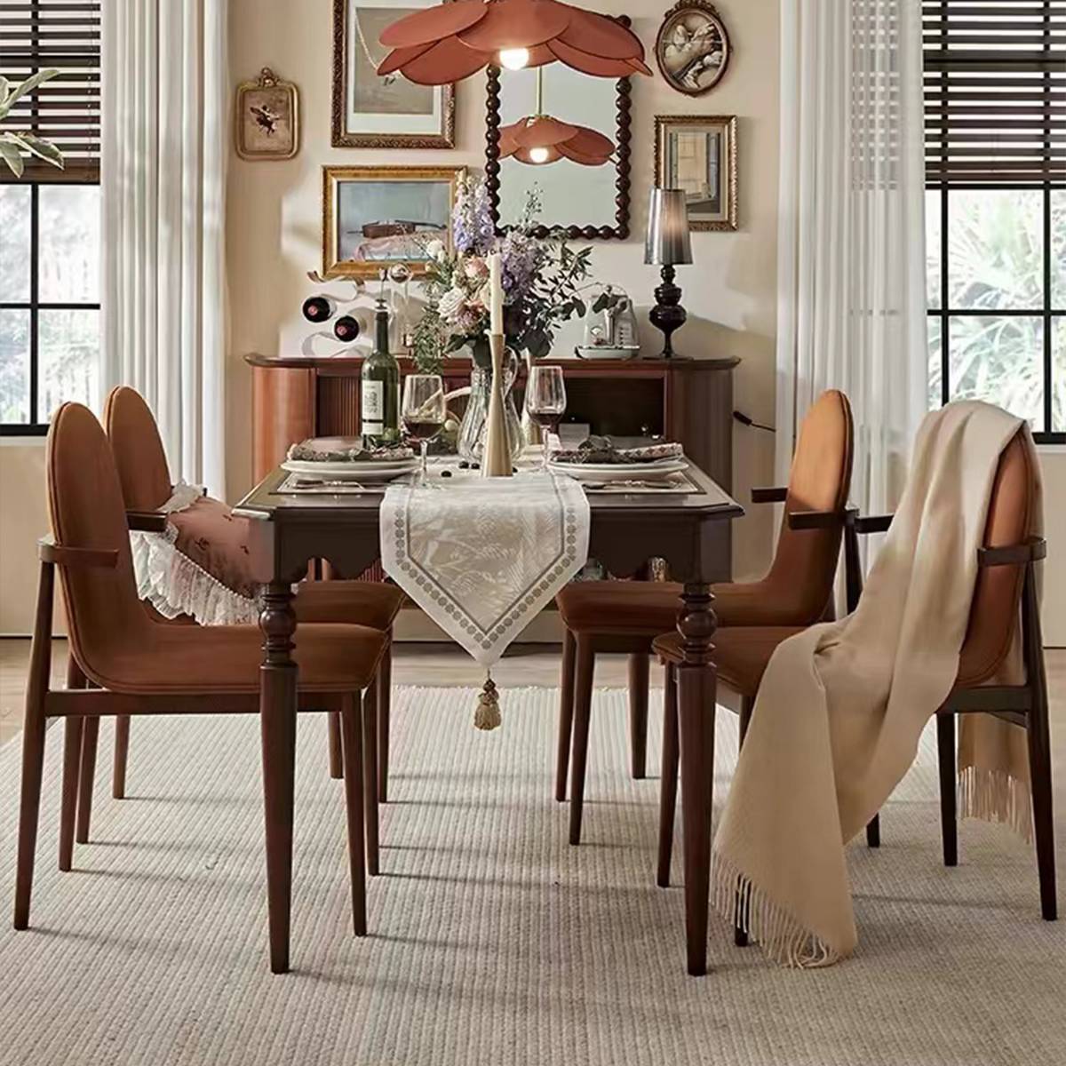 Dining table with table runner and throw blanket on chair