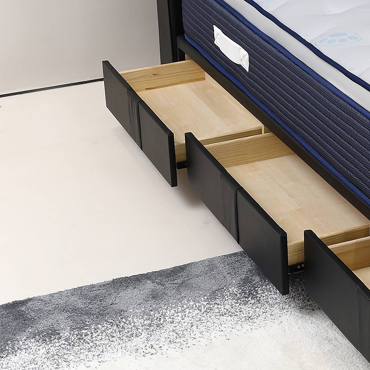 Open storage drawers showing the wooden interior of the bed frame