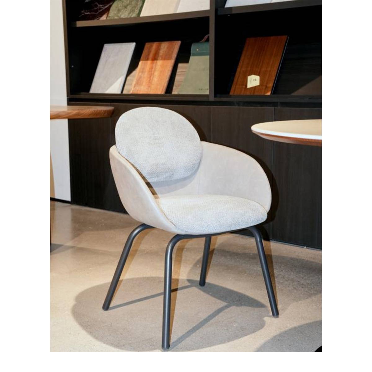 Light grey modern dining chair with carbon steel legs and mixed fabric upholstery