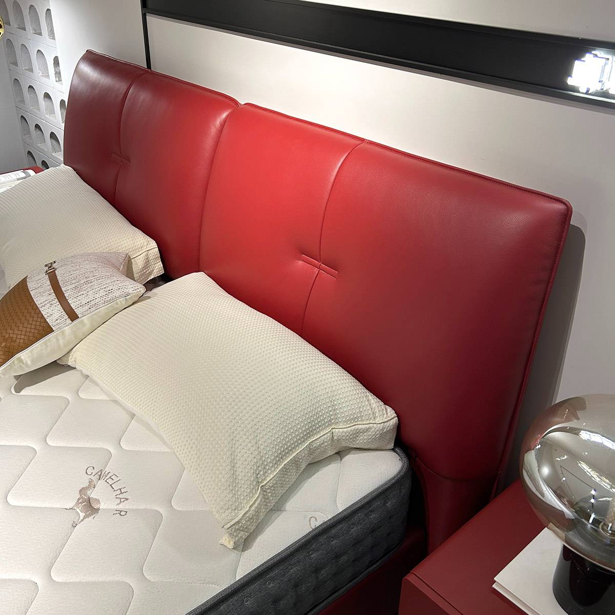 Close-up detail of the red leather headboard and mattress