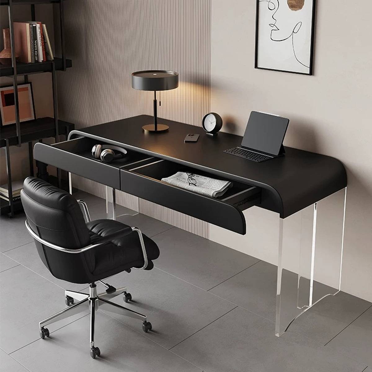 Black desk with open drawers, laptop, and office chair