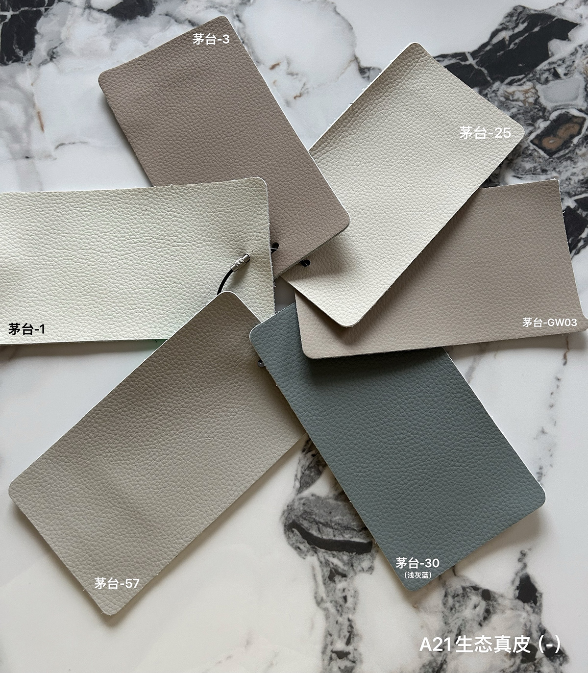 Close-up of leather swatches showing various color options including beige, grey, and blue.