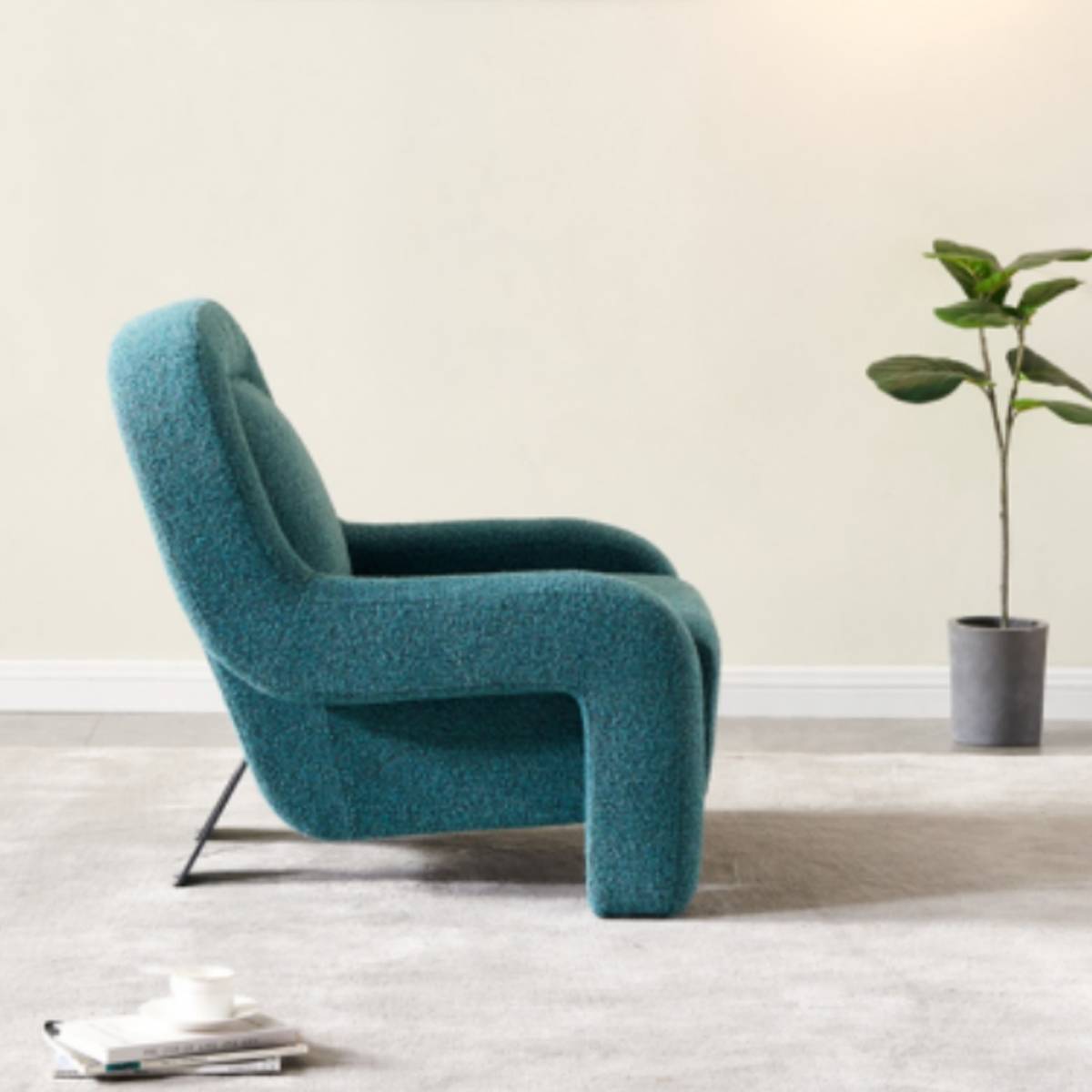 Side profile view of the teal curved lounge chair